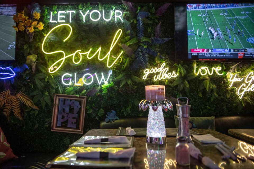 Neon lights with faux plants and flowers are displayed around the Soul Nashville in West Nashville, Tenn., Saturday, Nov. 11, 2023.