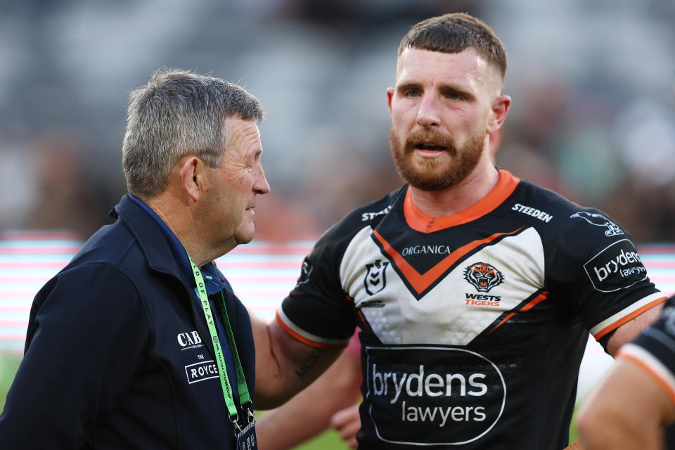 Jackson Hastings (pictured right) talks to Royce Simmons (pictured) after the round 18 NRL match between the Wests Tigers and the Penrith Panthers.