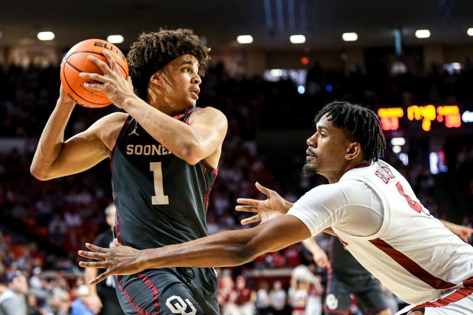 Oklahoma forward Jalen Hill (1) looks to pass as Alabama forward Noah Gurley (4) guards in the second half during a basketball game between The Oklahoma Sooners (OU) and The Alabama Crimson Tide at the Lloyd Noble Center in Norman, Okla., Saturday, Jan. 28, 2023.