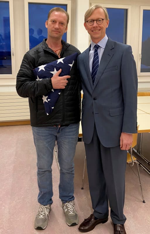 Michael White, a freed U.S. Navy veteran detained in Iran since 2018, poses with U.S. Special Envoy for Iran Brian Hook in Zurich