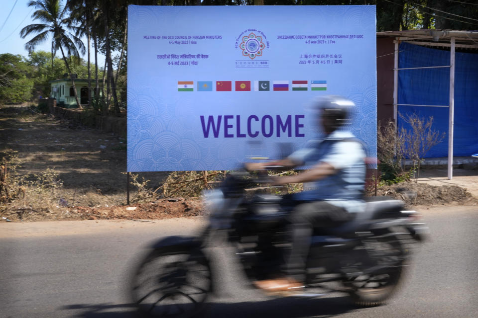 A motorcyclist drives past a huge banner welcoming the delegates of the Shanghai Cooperation Organization (SCO) council of foreign ministers meeting, in Goa, India, Wednesday, May 3, 2023. Russia is unlikely to face backlash over its war in Ukraine at an upcoming meeting of Central Asian foreign ministers and instead could flex its influence with the regional group. The meeting of the SCO ministers Friday in India's picturesque state of Goa is the latest avenue for the host nation to burnish its geopolitical credentials as it seeks to cement itself as a consequential global player. (AP Photo/Manish Swarup)