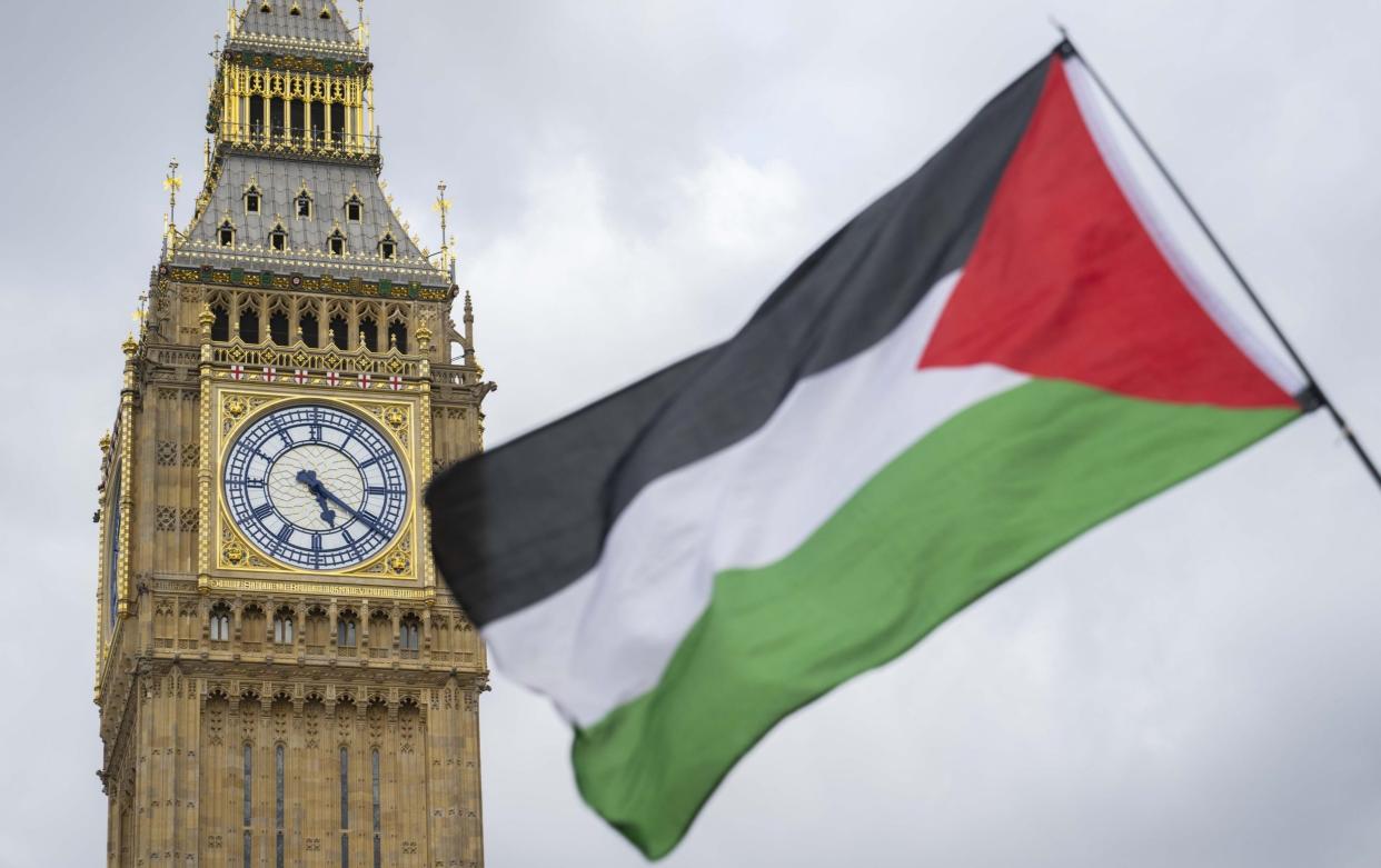 People holding banners against Israel march to Downing Street within the Al-Quds Day in London