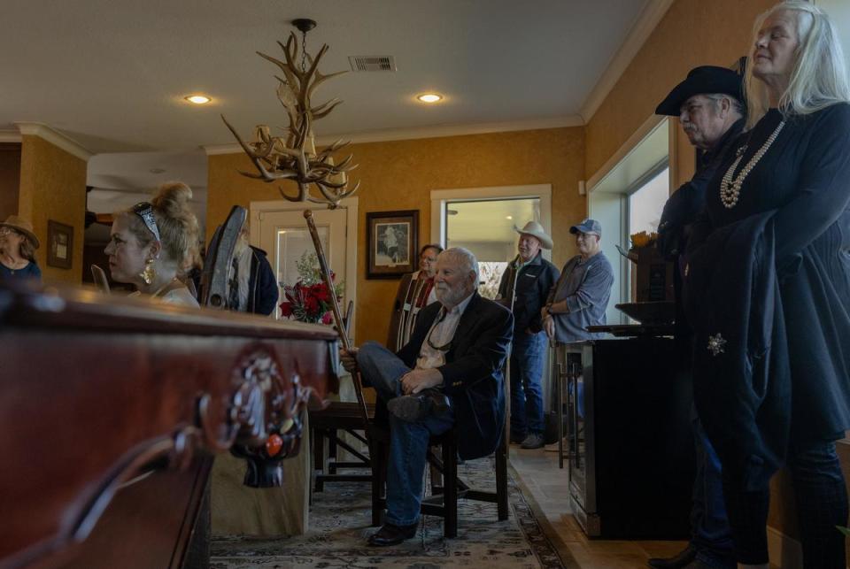 Attendees of Donald Green's celebration of life listen as loved ones share stories of Green's life, at a home in Freeport, on Dec. 16, 2023.