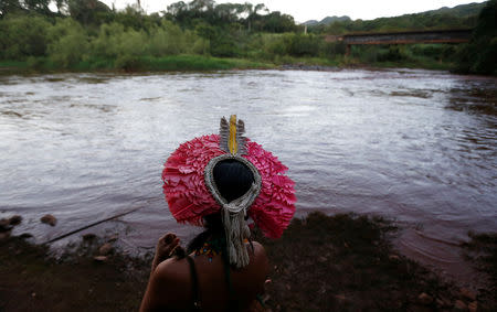 An Indigenous woman from the Pataxo Ha-ha-hae tribe looks at Paraopeba river, after a tailings dam owned by Brazilian mining company Vale SA collapsed, in Sao Joaquim de Bicas near Brumadinho, Brazil January 28, 2019. REUTERS/Adriano Machado