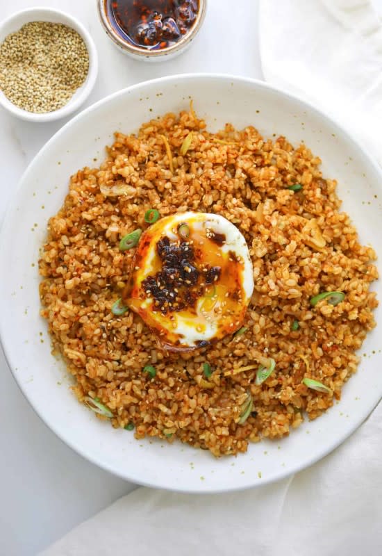 <p>Craving California</p><p>Hearty brown rice is cooked with probiotic-rich kimchi, garlic, ginger and soy sauce, then topped off with a crispy fried egg!</p><p><strong>Get the recipe: <a href="https://cravingcalifornia.com/kimchi-brown-rice-breakfast-bowls/" rel="nofollow noopener" target="_blank" data-ylk="slk:Kimchi Brown Rice Breakfast Bowls;elm:context_link;itc:0;sec:content-canvas" class="link ">Kimchi Brown Rice Breakfast Bowls</a></strong></p>