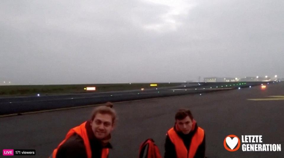 Climate activists glue themselves to a runway at the Berlin Brandenburg Airport (BER) during a protest (via REUTERS)