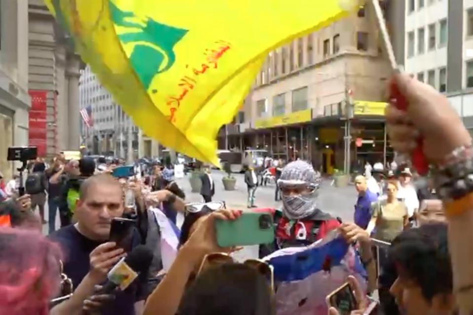 The yellow-and-green flag of the Hezbollah terrorist group waved over Manhattan on Monday during an anti-Israel rally. Olga Fe (FreedomNewsTV)