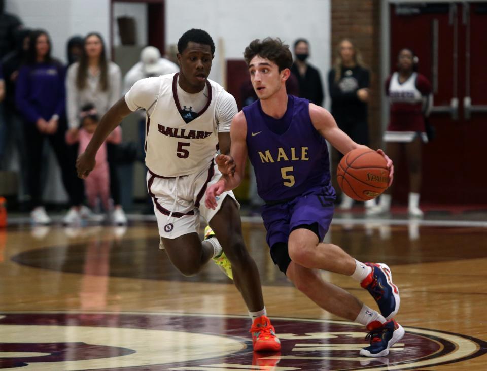 Male’s Jack Edelen drives the ball against Ballard’s Kaden StantonJan. 29, 2022