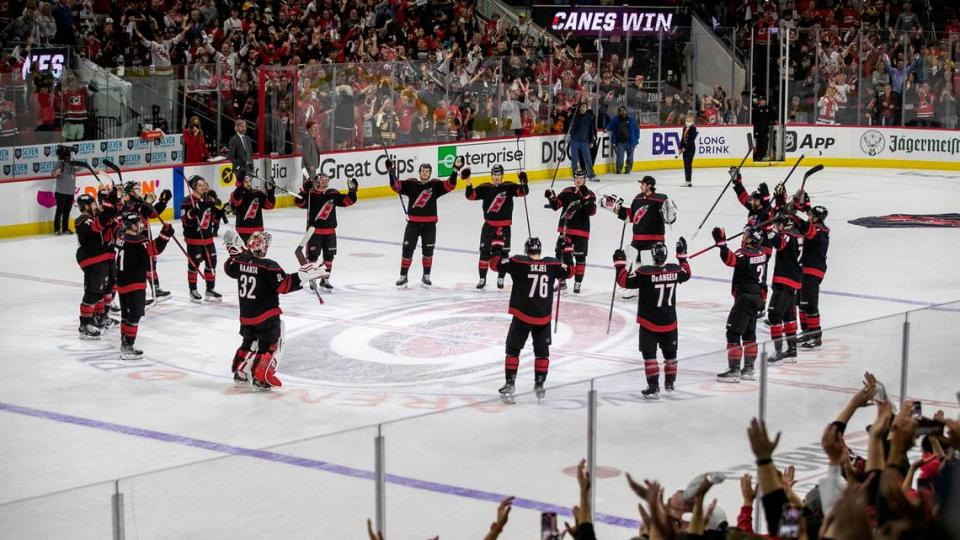 The Carolina Hurricanes celebrate their 3-2 victory over Boston after clinching the first round of their Stanley Cup series on Saturday, May 14, 2022 at PNC Arena in Raleigh, N.C.