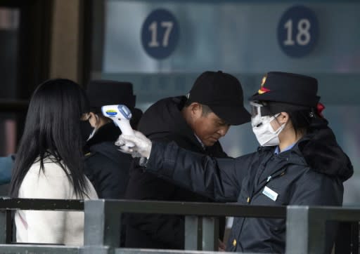 Passengers arriving in Beijing are being checked for fever, a symptom of the coronavirus infection