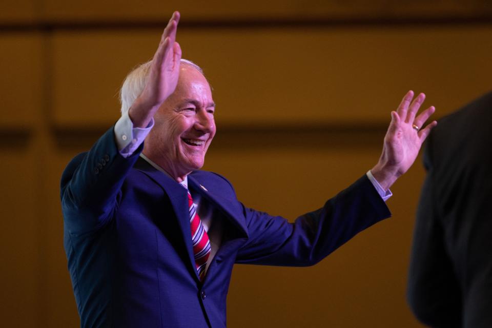 Former Arkansas Governor Asa Hutchinson waves as he attends the Vision 2024 National Conservative Forum at the Charleston Area Convention Center in Charleston, South Carolina, on March 18, 2023.