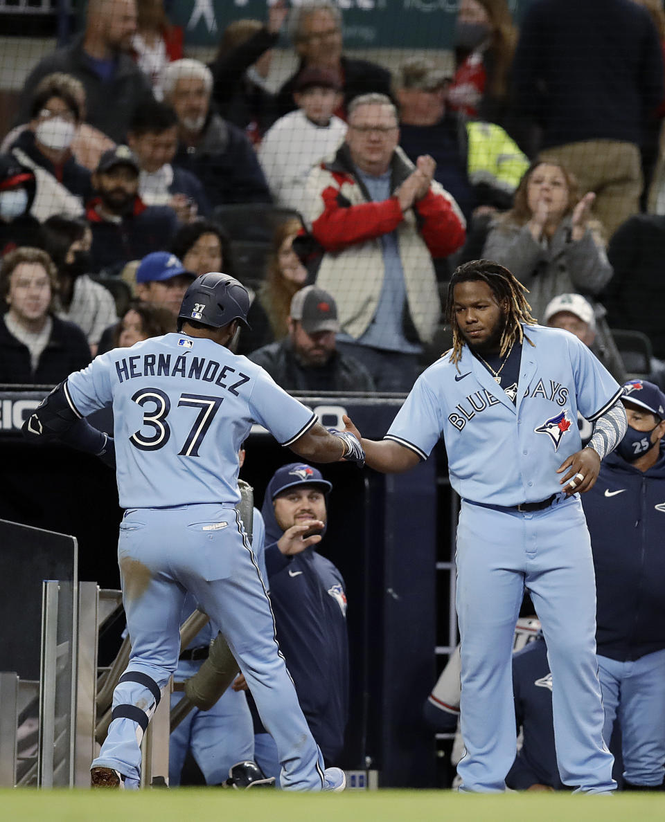 Toronto Blue Jays' Teoscar Hernandez (37) celebrates with Vladimir Guerrero Jr., right, after hitting a two-run home run against the Atlanta Braves during the ninth inning of a baseball game Wednesday, May 12, 2021, in Atlanta. (AP Photo/Ben Margot)