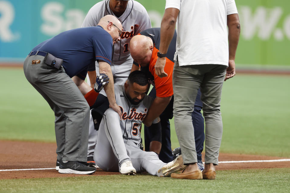 Detroit Tigers' Derek Hill lays is helped up off the field during the fifth inning of a baseball game against the Tampa Bay Ray Saturday, Sept. 18, 2021, in St. Petersburg, Fla. (AP Photo/Scott Audette)