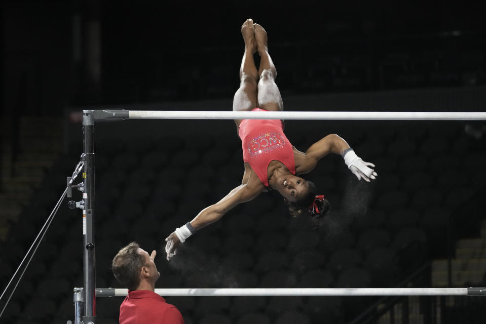 Simone Biles, a seven-time Olympic medalist and the 2016 Olympic champion, practices performs on the uneven bars at the U.S. Classic gymnastics competition Friday, Aug. 4, 2023, in Hoffman Estates, Ill. (AP Photo/Morry Gash)