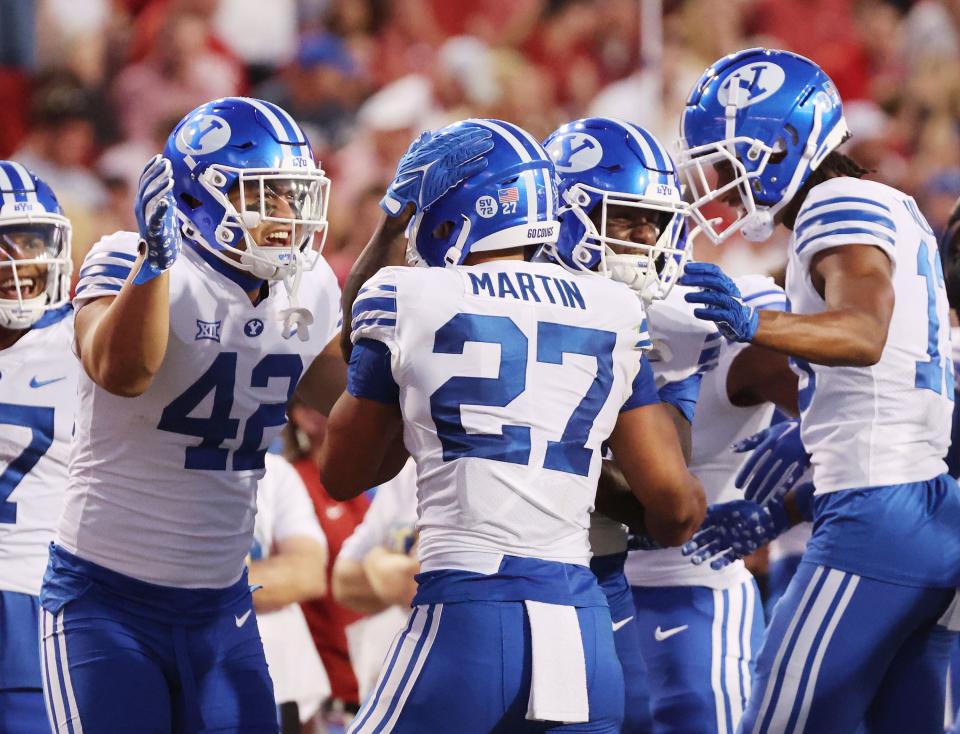Brigham Young Cougars running back LJ Martin (27) celebrates his touchdown at Razorback Stadium in Fayetteville on Saturday, Sept. 16, 2023. | Jeffrey D. Allred, Deseret News