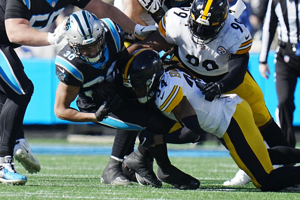 Carolina Panthers running back Chuba Hubbard is tackled by Pittsburgh Steelers safety Terrell Edmunds an NFL football game between the Carolina Panthers and the Pittsburgh Steelers on Sunday, Dec. 18, 2022, in Charlotte, N.C. (AP Photo/Rusty Jones)