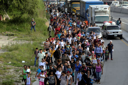 A large group of Hondurans fleeing poverty and violence, move in a caravan toward the United States, in San Pedro Sula, Honduras October 13, 2018. REUTERS/Jorge Cabrera
