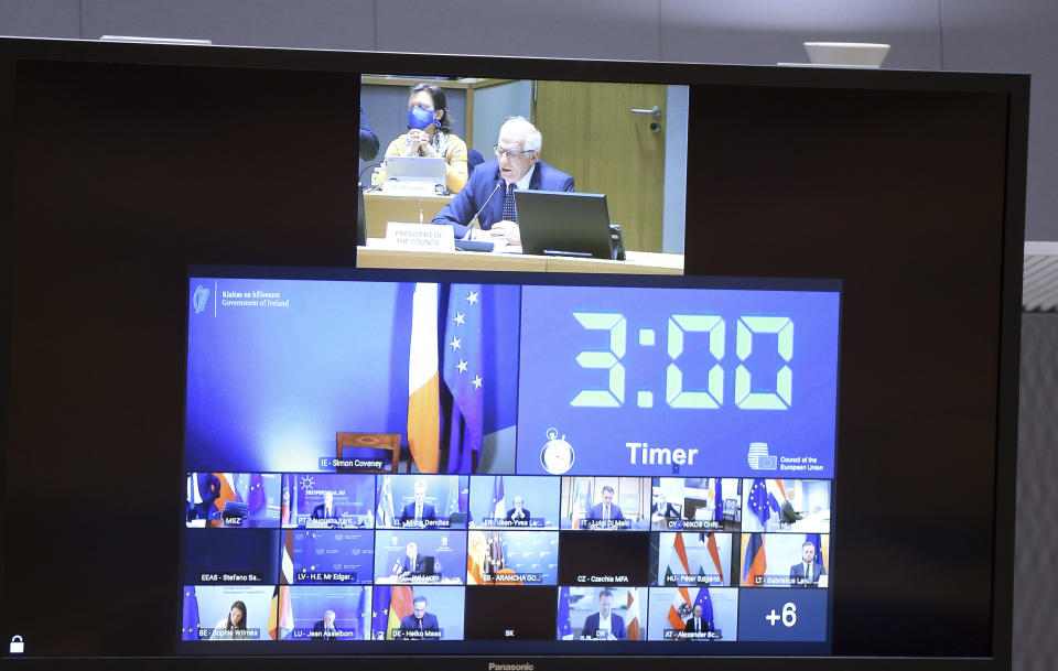 European Union foreign policy chief Josep Borrell, top of screen, speaks with EU foreign ministers via video link at the European Council building in Brussels, Monday, April 19, 2021. European Union foreign ministers on Monday assessed the bloc's strategy towards Russia in the wake of the military buildup on Ukraine's borders and amid the weakening health of imprisoned opposition leader Alexei Navalny. (Francois Walschaerts, Pool via AP)