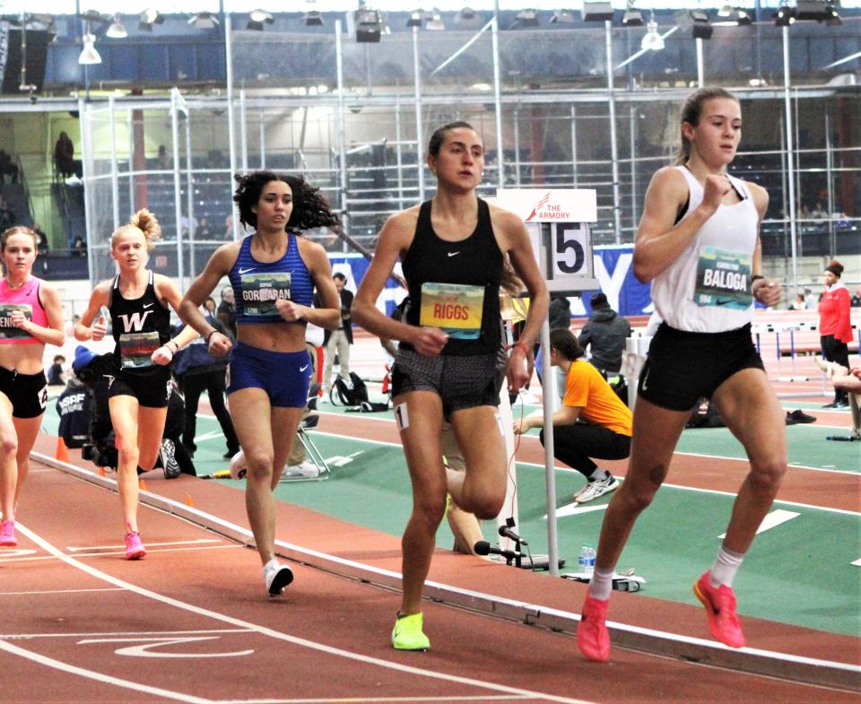 Karrie Baloga (r) of Cornwall leads eventual champion Irene Riggs of West Virginia before taking silver in the girls mile in a personal-best time during the Nike Indoor Nationals at The Armory March 12, 2023..