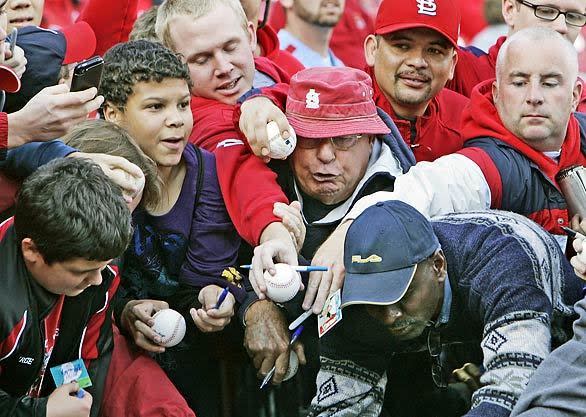 Fans squeeze together for a chance to get Dodgers outfielder Matt Kemp to sign an autograph before the start of Game 3 at Busch Stadium on Saturday.