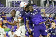 Orlando City's Junior Urso, center, and Daryl Dike (18) try to he'd the ball toward the goal as CF Montreal's Kamal Miller (3) defends during the second half of an MLS soccer match, Wednesday, Oct. 20, 2021, in Orlando, Fla. (AP Photo/John Raoux)