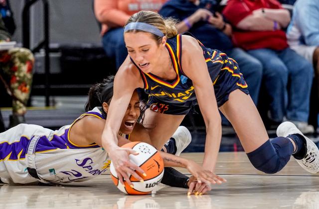 The Indiana Fever's Lexie Hull (10) and the Los Angeles Sparks Jordin Canada (21) battle for a loose ball during a game between the Indiana Fever and the Los Angeles Sparks on Sunday, May 8, 2022, at Gainbridge Fieldhouse in Indianapolis. 