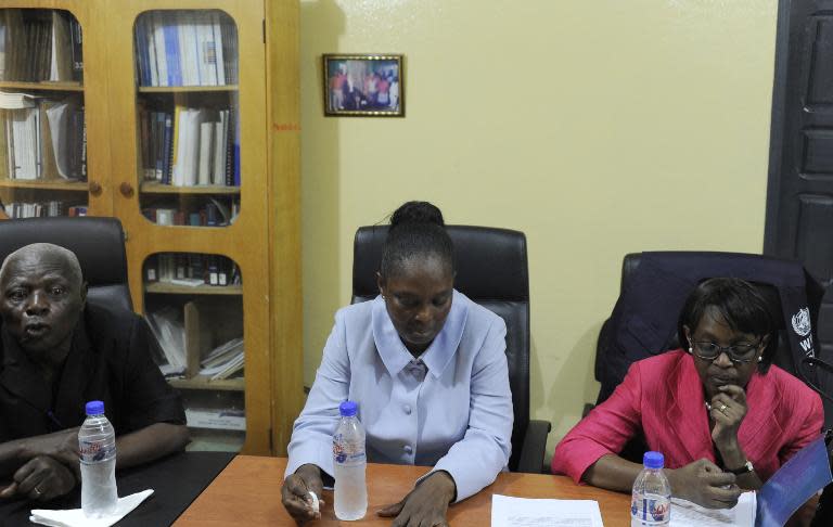 Mohamed Sankor, medical director of the Redemption Hospital, speaks as Liberian Health Minister Burnice Dahn (C) and the director of the WHO for the Africa region, Matshidiso Moeti (R) visit in New Kru Town outside Monrovia, on April 22, 2015