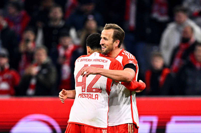Bayern Munich's Harry Kane (R) celebrates with team-mate Jamal Musiala after scoring his side's first goal for the game during the German Bundesliga soccer match between Bayern Munich and RB Leipzig at Allianz Arena. Tom Weller/dpa