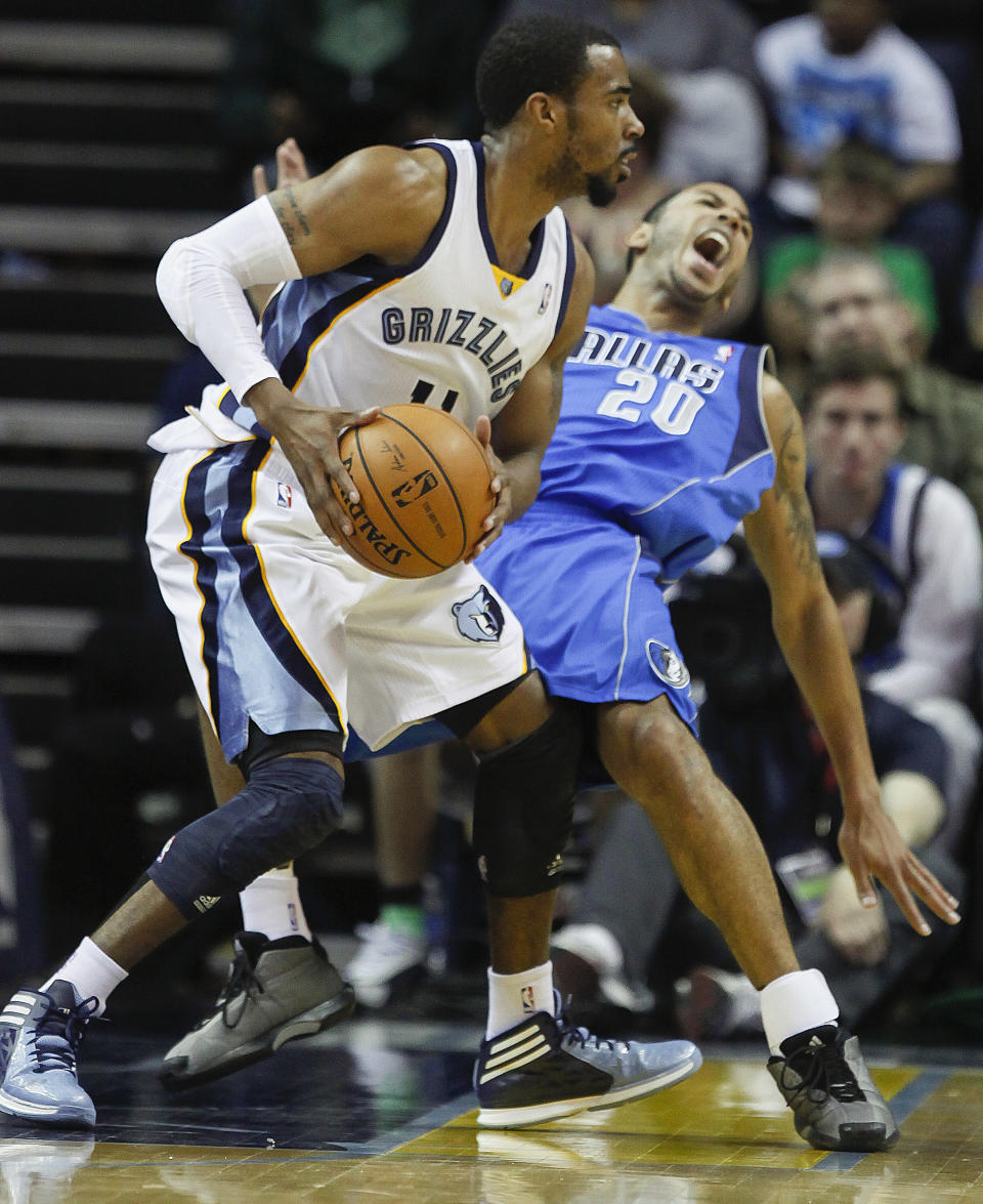 Memphis Grizzlies guard Mike Conley (11) runs into Dallas Mavericks guard Devin Harris (20) in the first half of an NBA basketball game Wednesday, April 16, 2014, in Memphis, Tenn. (AP Photo/Lance Murphey)