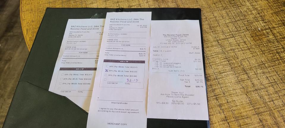 Two bills with different tip amounts for the same breakfast at The Rooster.