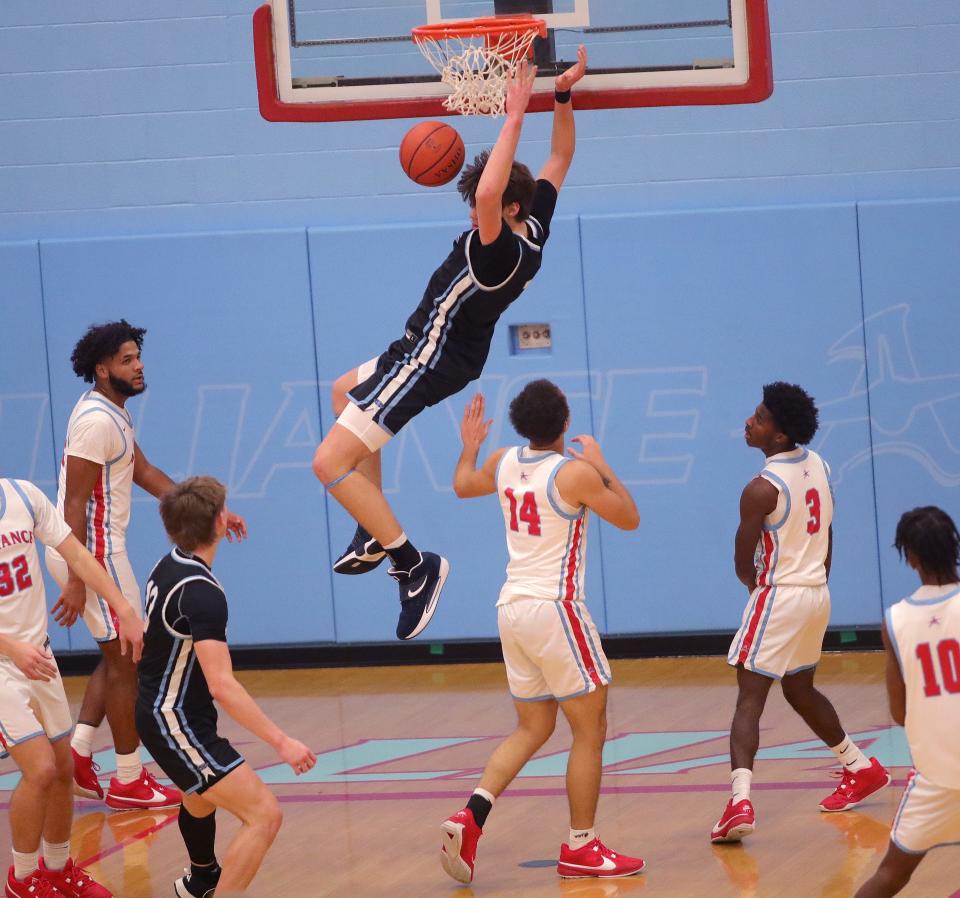 Louisville's Brayden Gross dunks the ball at Alliance, Tuesday, Dec. 12, 2023.