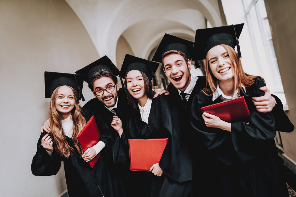 Graduating university students smile as they look ahead to a career.