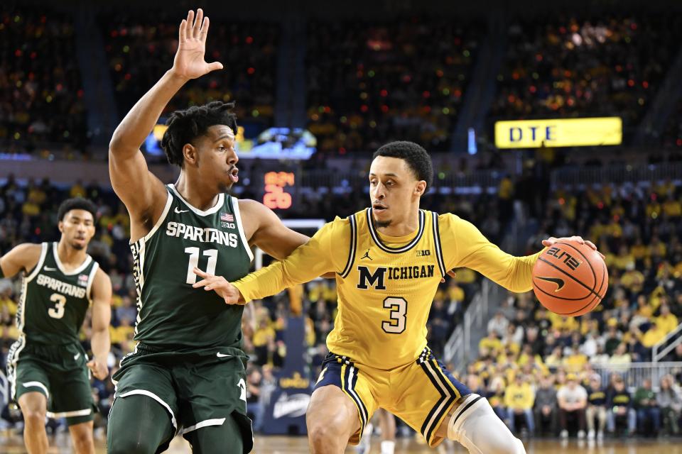 Jaelin Llewellyn of the Michigan Wolverines dribbles against A.J. Hoggard of the Michigan State Spartans in the first half at Crisler Center in Ann Arbor on Saturday, Feb. 17, 2024.