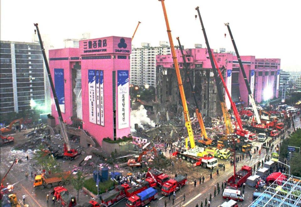 Using cranes to lift heavy debris, crews hunt for survivors and bodies following the June 29, 1995, collapse of Seoul’s Sampoong Department Store. More than 500 died.