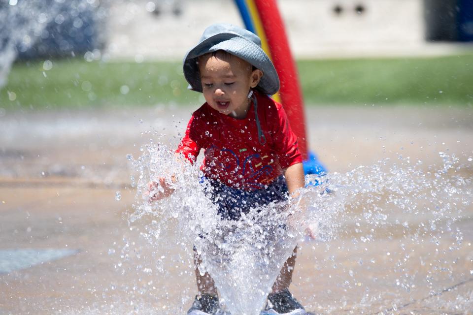 Emiliano Romero, 1, plays with a water spout at the Bill Witt Park Splash Pad Thursday, July 6, 2023.