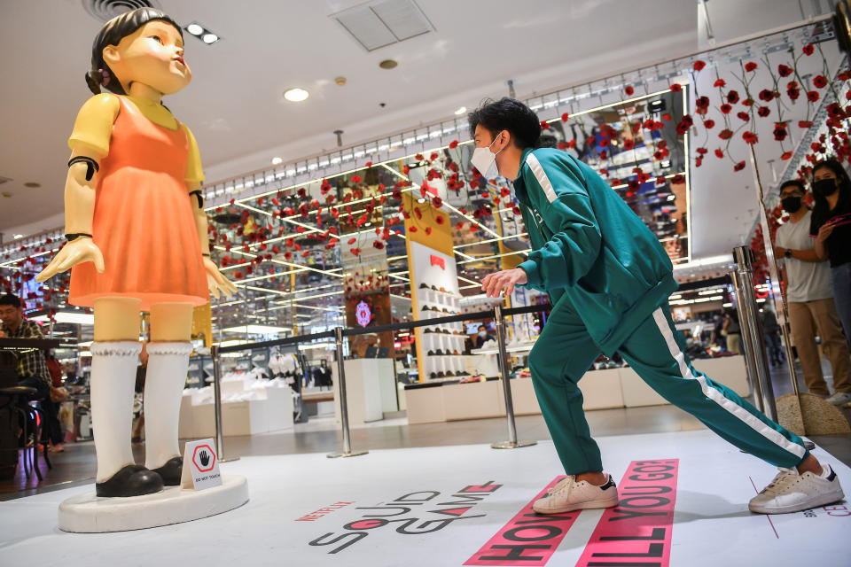 A man wearing a costume from the Netflix series 'Squid Game' participates in a mission at a department store in Bangkok, Thailand, November 20, 2021. REUTERS/Chalinee Thirasupa