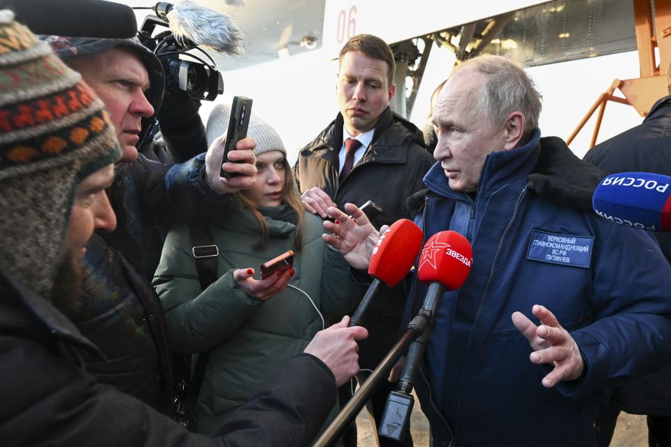 Russian President Vladimir Putin speaks to journalists as he gets off a Tu-160M strategic bomber after a flight in Kazan, Russia, Thursday, Feb. 22, 2024. (Dmitry Azarov, Sputnik, Kremlin Pool Photo via AP)