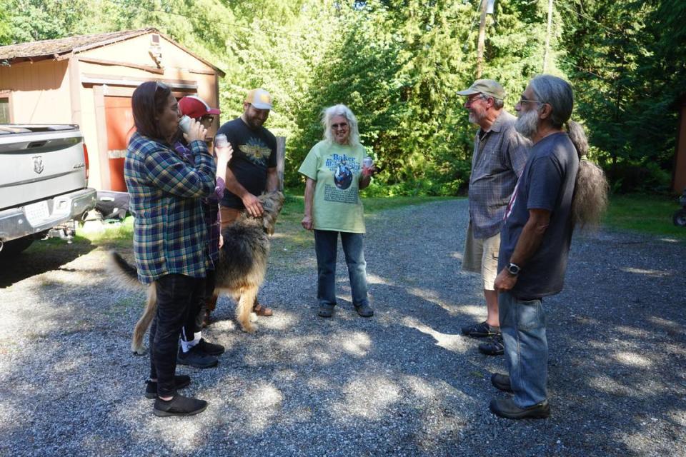 A group of residents that live near the proposed Ranch Quarry Mine site, and oppose the project, gather at Andrew Clarke’s property on Sept. 1, 2023, in Whatcom County, Wash. Clarke’s property borders the proposed mine site.