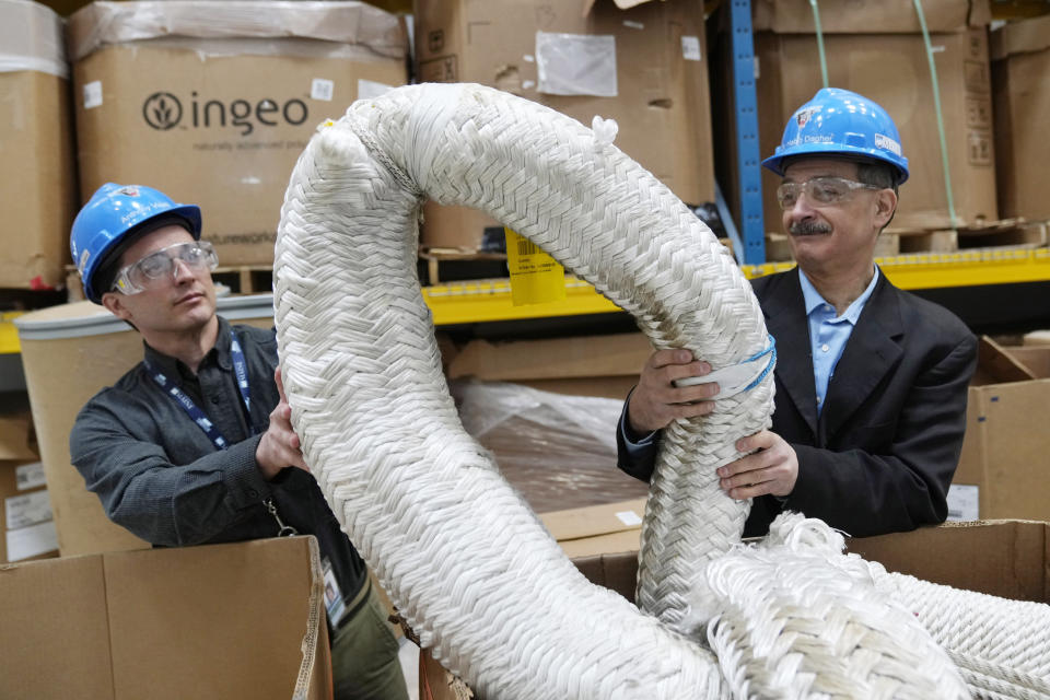 Anthony Viselli, manager of offshore model testing and structure design, left, and Habib Dagher, director of the advanced composites center, examine used anchor cables used for securing floating offshore wind turbines to the ocean floor, Wednesday, March 27, 2024, at the University of Maine, in Orono, Maine. (AP Photo/Robert F. Bukaty)