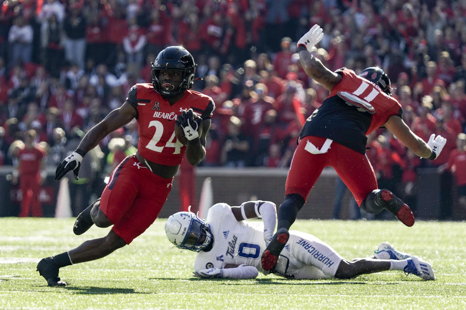 Cincinnati running back Jerome Ford (24) carries the ball during the first half of an NCAA college football game against Tulsa Saturday, Nov. 6, 2021, in Cincinnati. (AP Photo/Jeff Dean)