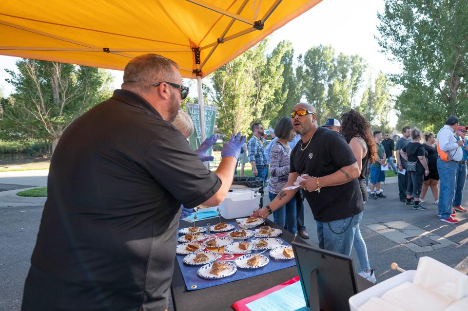 People line up at the Papa Mario's grilled cheese food truck for samples during the Governor's Plate competition at the Colorado State Fair on Tuesday, August 29, 2023.