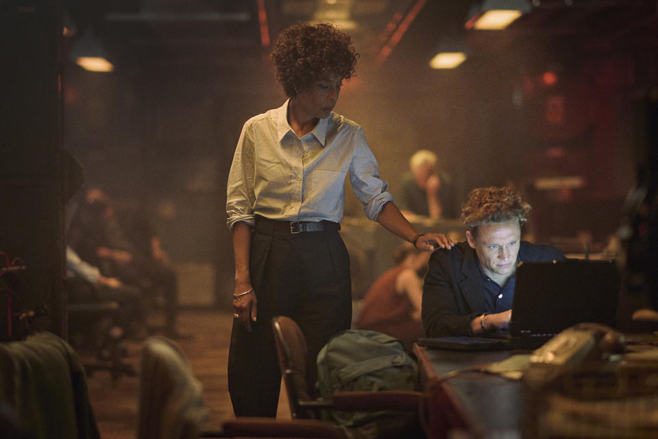 This image released by Netflix shows Sophie Okonedo, left, and Matthias Schweighöfer in a scene from "Heart of Stone." (Robert Viglasky/Netflix via AP)