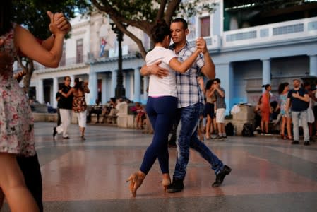 People dance tango during a weekly Sunday milonga on Havana's Paseo del Prado promenade