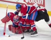 Montreal Canadiens goaltender Carey Price (31) grabs the puck as defenseman Ben Chiarot (8) and Ottawa Senators left wing Brady Tkachuk (7) look for the rebound during the first period of an NHL hockey game Tuesday, March 2, 2021, in Montreal. (Ryan Remiorz/The Canadian Press via AP)