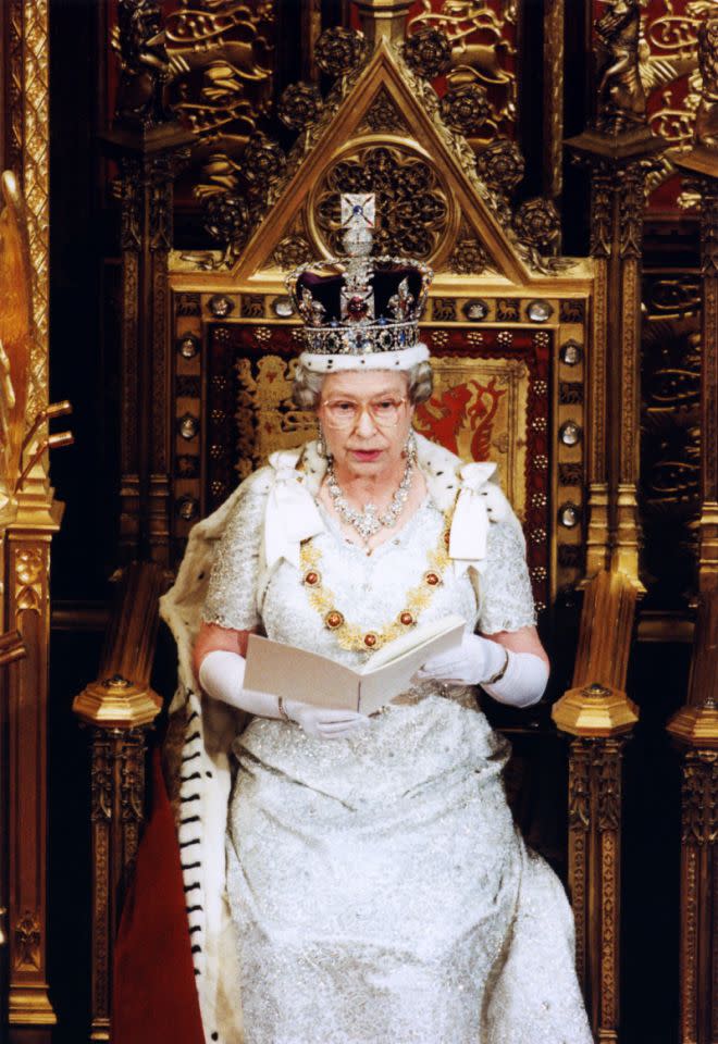 <p>Dressed in her full regalia, The Queen sits in the House of Lords for the state opening of parliament. (PA Archive) </p>