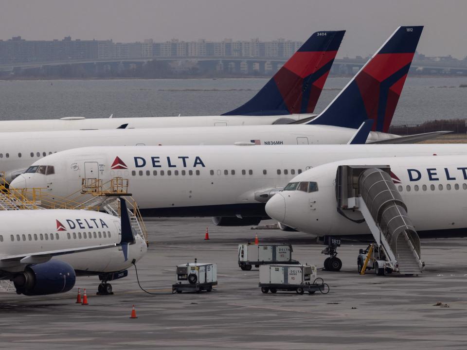 Delta Airlines passenger aircrafts are seen on the tarmac of John F. Kennedy International Airpot in New York,on December 24, 2021. - Over 2,000 flights have been cancelled and thousands delayed around the world as the highly infectious Omicron variant disrupts holiday travel. (Photo by Yuki IWAMURA / AFP) (Photo by YUKI IWAMURA/AFP via Getty Images)