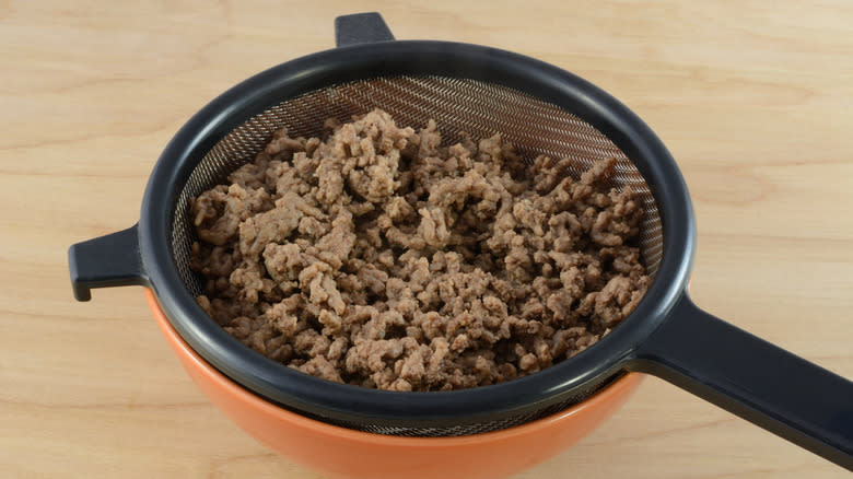 Ground beef draining in colander 