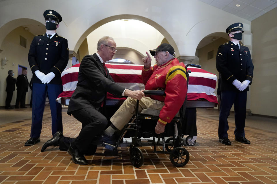 World War II veteran Alexander Freidenberger, 97, talks to Sen. Jerry Moran, R-Kan., before a memorial service for former Sen. Bob Dole, R-Kan., Saturday, Dec. 11, 2021, in Russell, Kan. (AP Photo/Charlie Riedel)