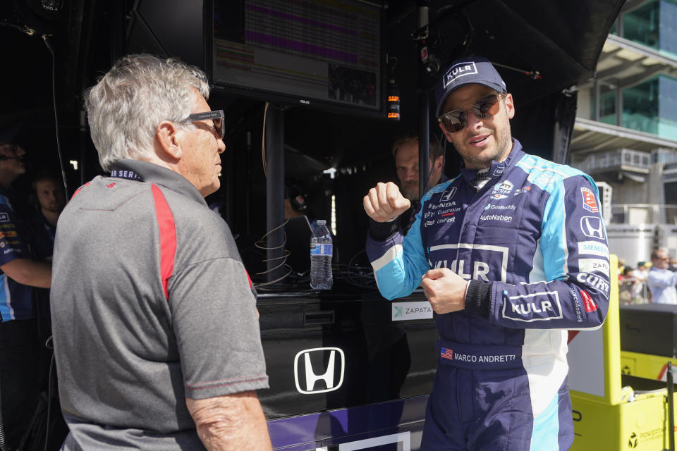 Marco Andretti talks with Mario Andretti during practice for the Indianapolis 500 auto race at Indianapolis Motor Speedway, Tuesday, May 17, 2022, in Indianapolis. (AP Photo/Darron Cummings)