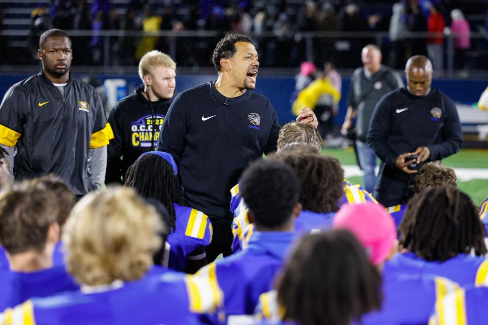 Gahanna Lincoln coach Bruce Ward talks to his players after the Lions' 35-28, double-overtime win against visiting Pickerington North on Friday.